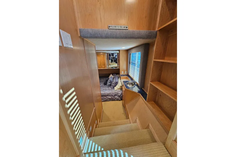Slide: The Image of Interior of 2001 Sumerset 16x79 houseboat with cozy bedroom and wooden cabinetry. - 20