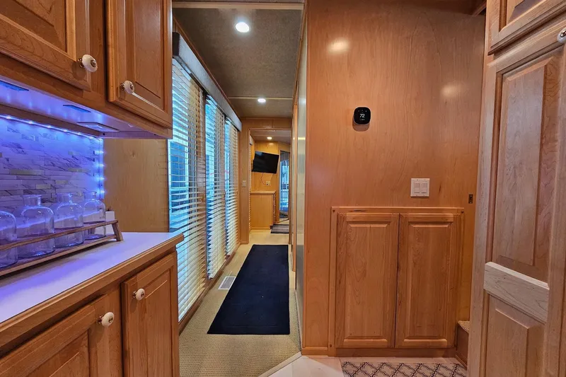 Slide: The Image of Interior of a 2001 Sumerset 16x79 houseboat with wooden cabinetry and modern lighting. - 29
