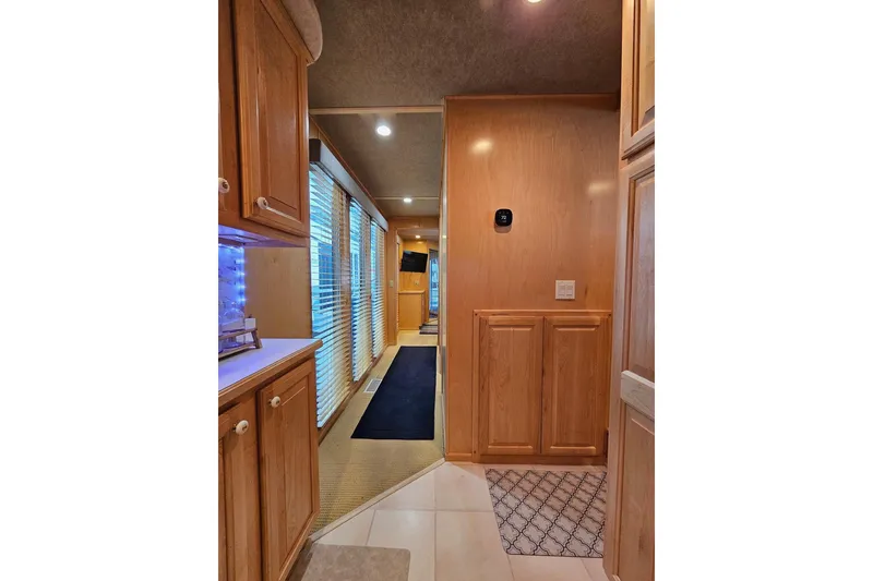 Slide: The Image of Interior of 2001 Sumerset 16x79 houseboat with wooden cabinets and hallway. - 30