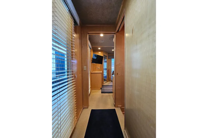 Slide: The Image of Hallway inside 2001 Sumerset 16x79 houseboat with wooden walls and window blinds. - 35
