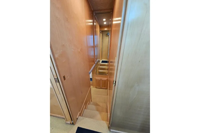 Slide: The Image of Interior hallway of a 2001 Sumerset 16x79 houseboat with wooden walls and carpeted stairs. - 36