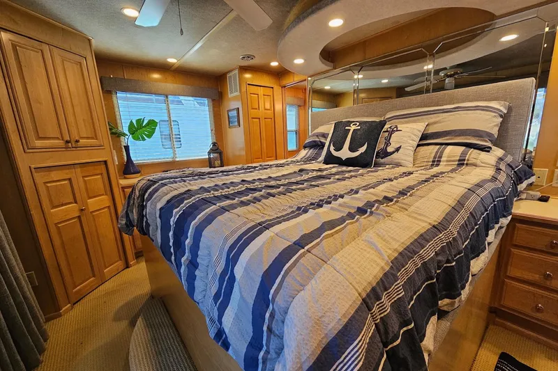 Slide: The Image of Cozy bedroom in a 2001 Sumerset 16x79 houseboat with nautical-themed decor. - 40