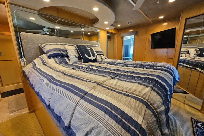 Slide: The Image of Luxurious bedroom in a 2001 Sumerset 16x79 houseboat with nautical-themed decor. - 41