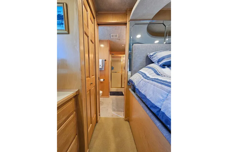 Slide: The Image of Interior of 2001 Sumerset 16x79 houseboat with cozy bedroom and hallway view. - 43