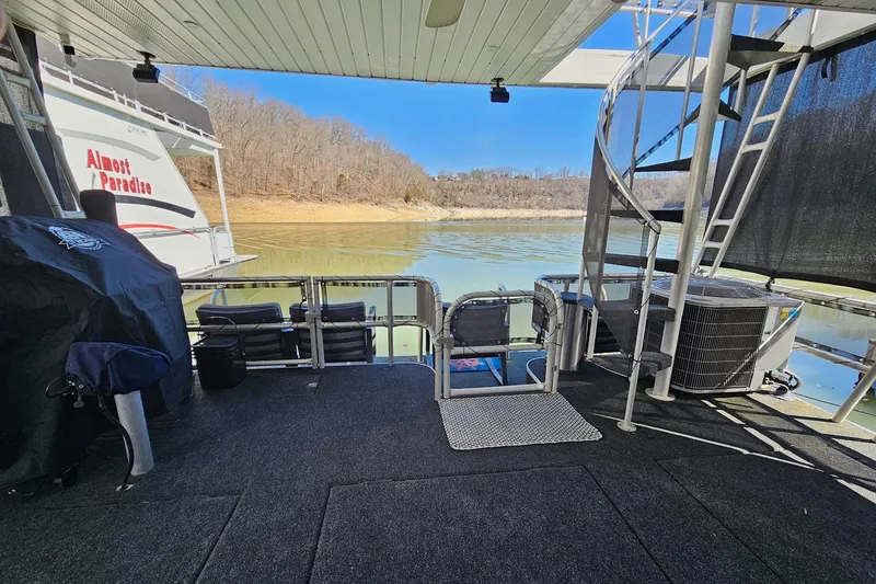 Slide: The Image of Houseboat deck with spiral staircase, grill, and scenic lake view; Sumerset 16x79, 2001 model. - 51