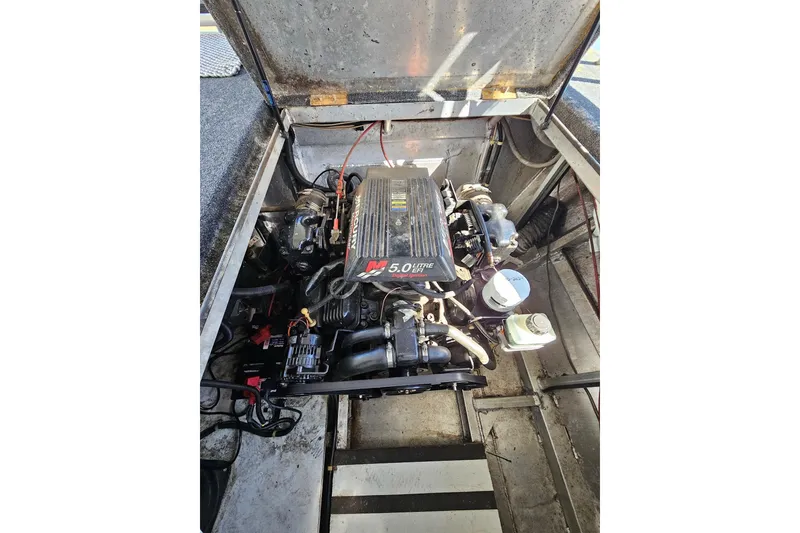 Slide: The Image of Engine compartment of a 2001 Sumerset 16x79 houseboat, featuring a 5.0L MerCruiser engine. - 54