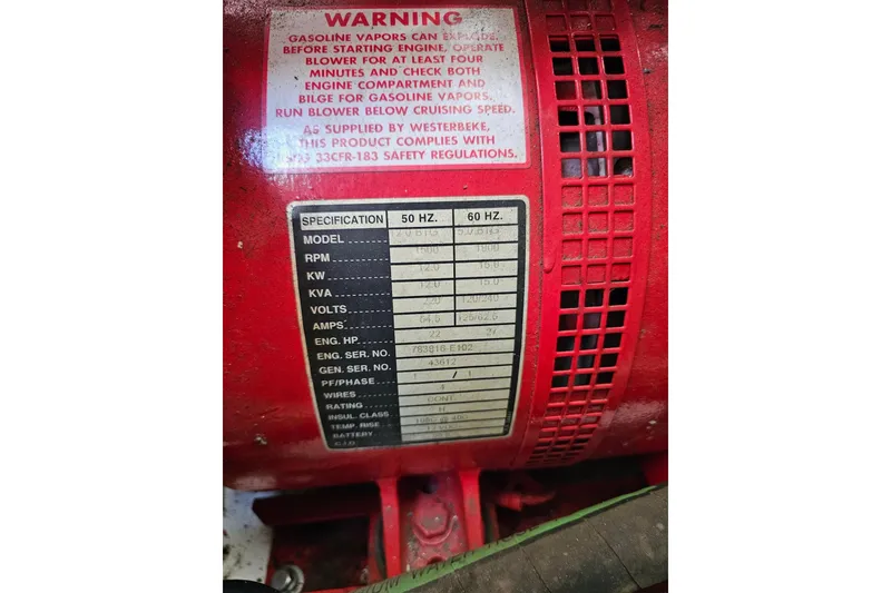Slide: The Image of Warning label and specifications on a red engine component, Sumerset 16x79, 2001 model. - 57