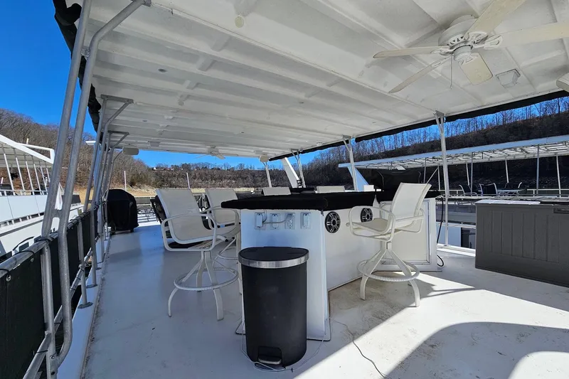 Slide: The Image of Upper deck of 2001 Sumerset 16x79 houseboat with seating and ceiling fan. - 59