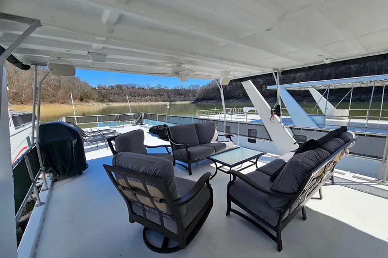 Slide: The Image of Outdoor seating area on a 2001 Sumerset 16x79 houseboat with scenic lake view. - 61
