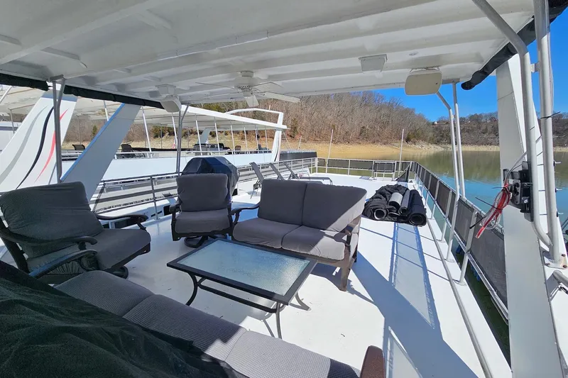 Slide: The Image of Spacious deck of 2001 Sumerset 16x79 houseboat with comfortable seating and scenic lake view. - 62