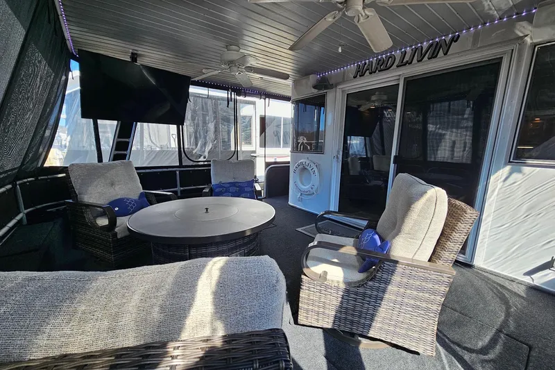 Slide: The Image of Luxurious 2001 Sumerset 16x79 houseboat interior with cozy seating and modern amenities. - 7