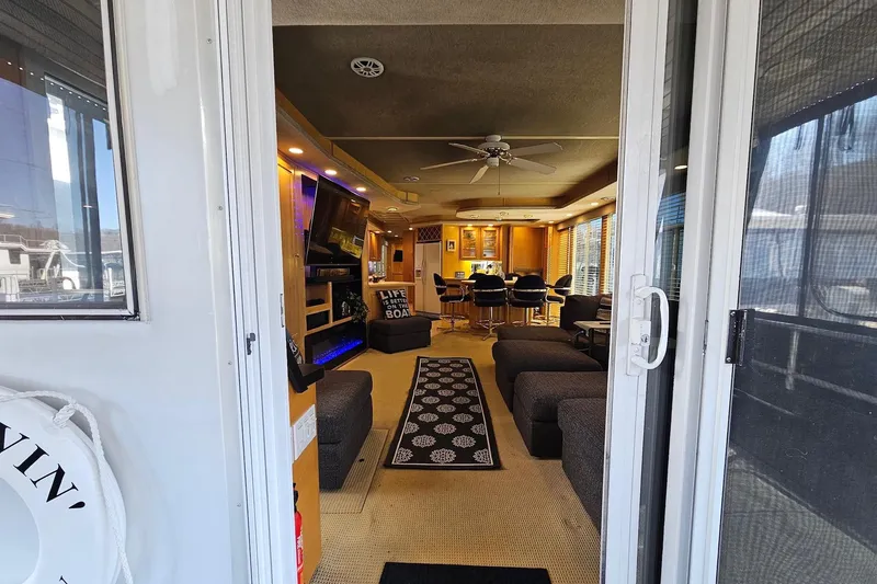 Slide: The Image of Interior view of a 2001 Sumerset 16x79 houseboat, featuring modern furnishings and decor. - 8