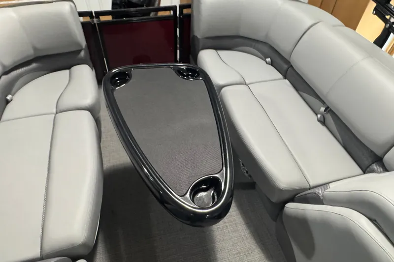 Slide: The Image of Luxurious seating area on 2025 Regency 230 DL3 pontoon boat with sleek table design. - 15