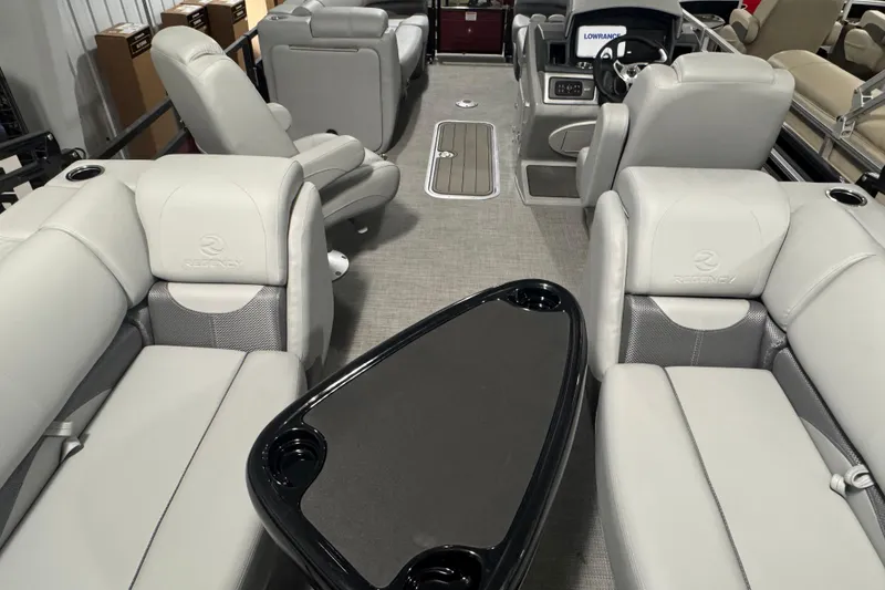 Slide: The Image of Luxurious interior of 2025 Regency 230 DL3 pontoon boat with plush seating and modern dashboard. - 17