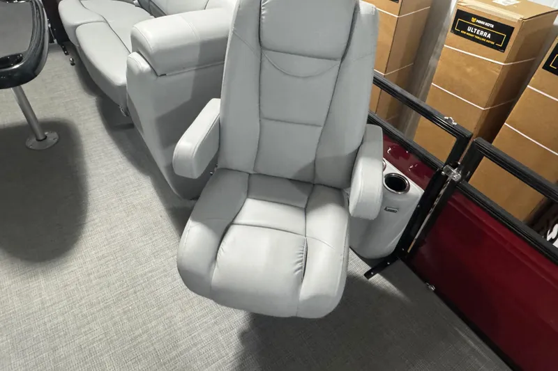 Slide: The Image of Luxurious seating on 2025 Regency 230 DL3 boat, featuring plush gray upholstery. - 8