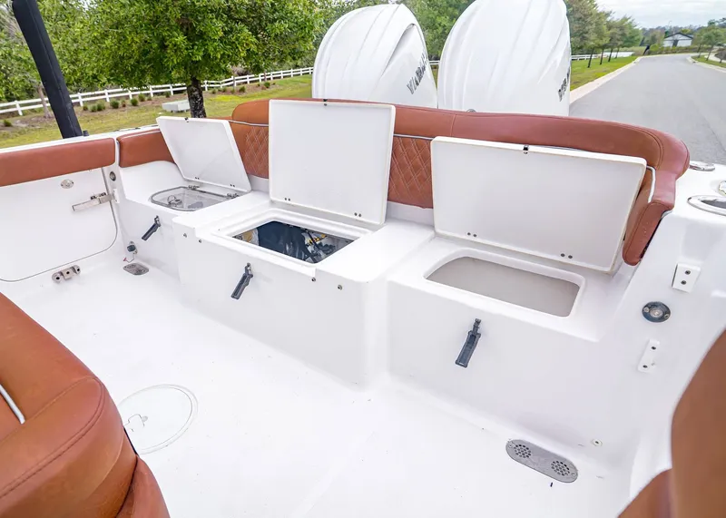 Slide: The Image of Interior view of 2024 Sea Hunt Ultra 265 SE boat with storage compartments. - 12