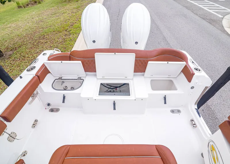 Slide: The Image of 2024 Sea Hunt Ultra 265 SE boat rear with storage compartments and engines. - 13