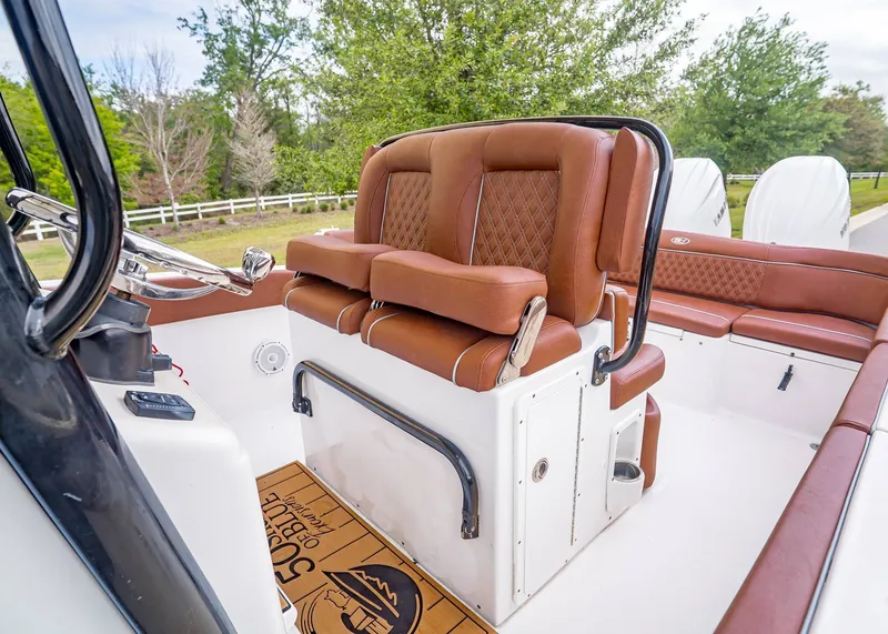 Slide: The Image of Interior of 2024 Sea Hunt Ultra 265 SE with brown leather seats. - 20