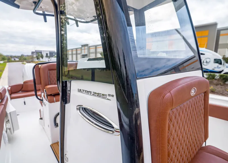 Slide: The Image of 2024 Sea Hunt Ultra 265 SE boat with brown leather seats. - 21
