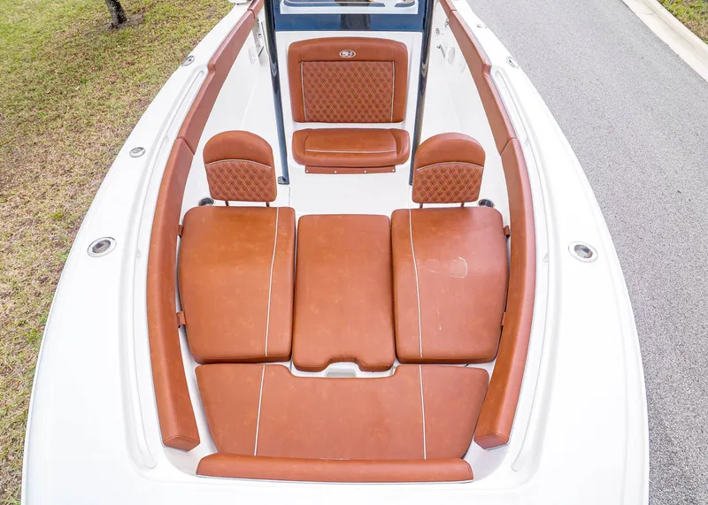 Slide: The Image of 2024 Sea Hunt Ultra 265 SE boat with brown leather seating. - 24