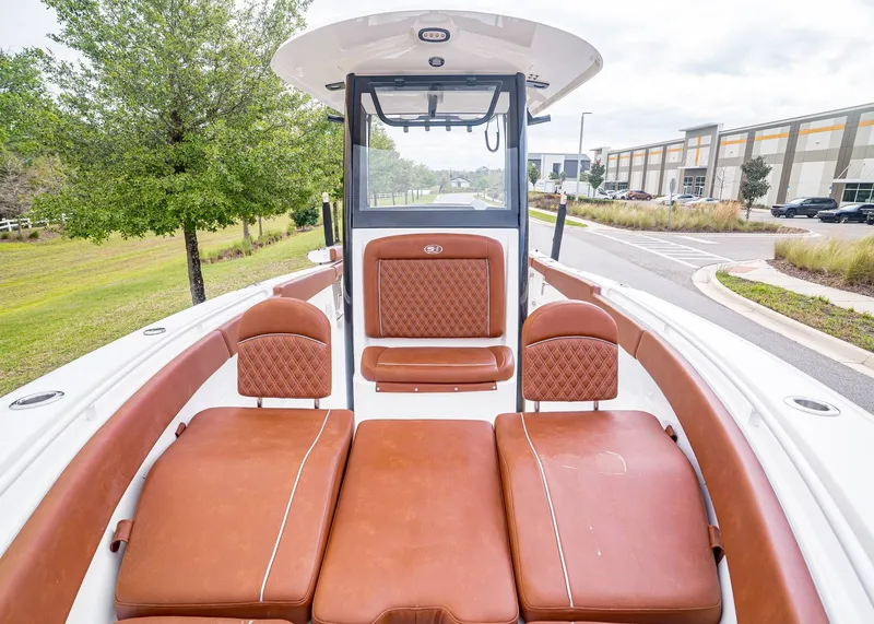 Slide: The Image of 2024 Sea Hunt Ultra 265 SE with brown leather seating. - 25