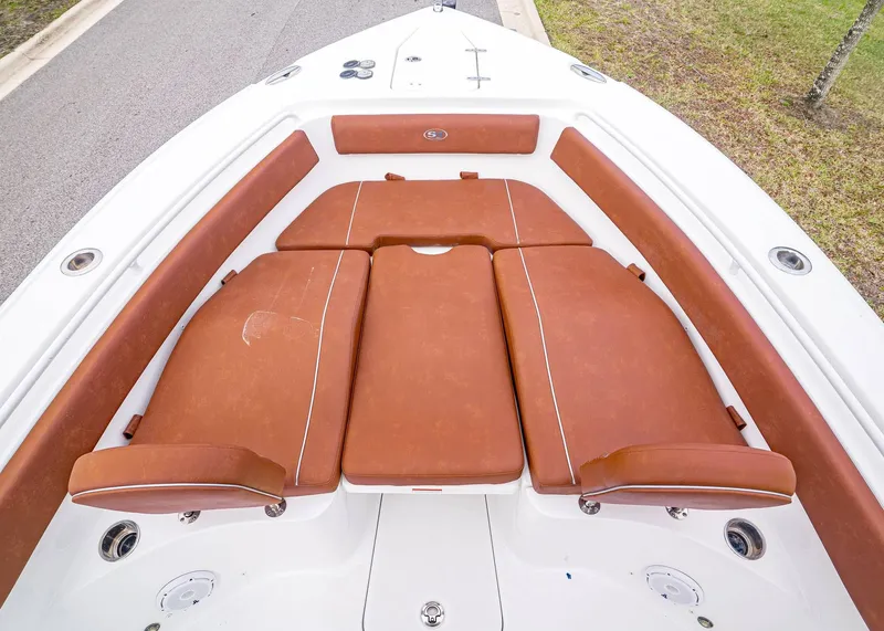 Slide: The Image of 2024 Sea Hunt Ultra 265 SE with brown cushions in the bow area. - 26