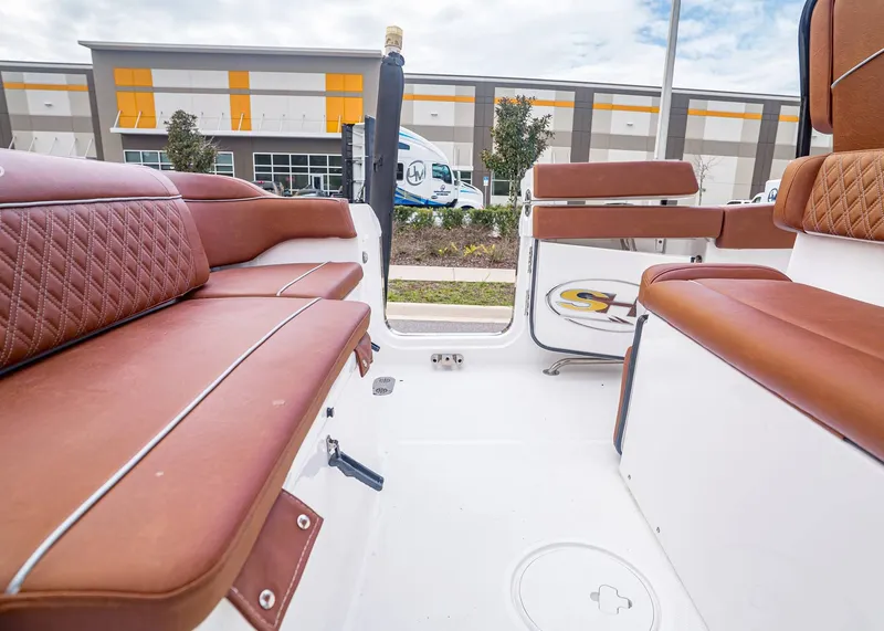 Slide: The Image of Interior of 2024 Sea Hunt Ultra 265 SE with brown leather seating. - 8