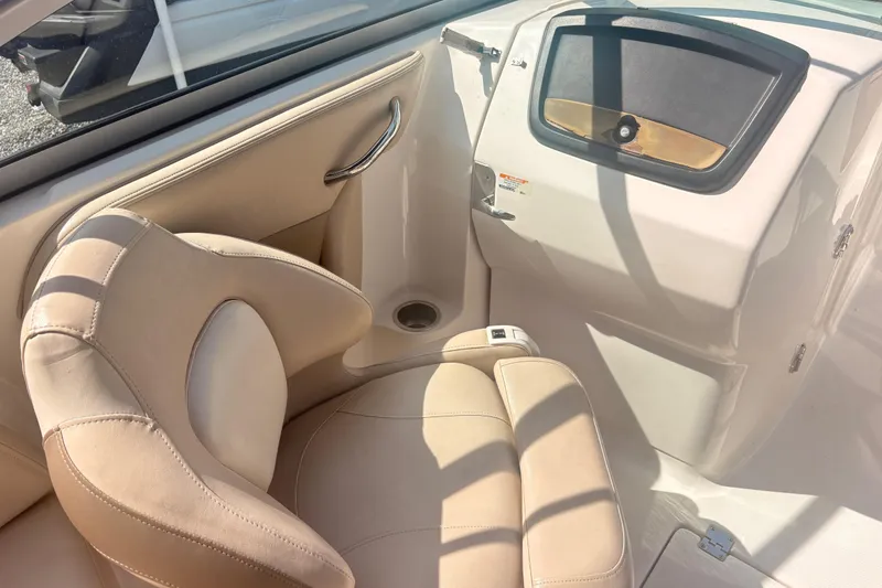 Slide: The Image of Interior of 2011 Chaparral 244 Sunesta boat with beige seating and dashboard. - 12