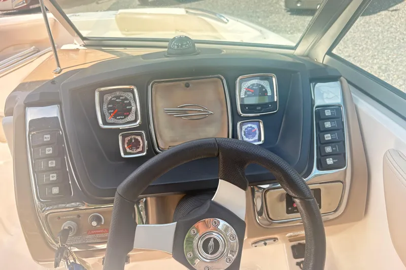 Slide: The Image of Dashboard of a 2011 Chaparral 244 Sunesta boat with steering wheel and gauges. - 14