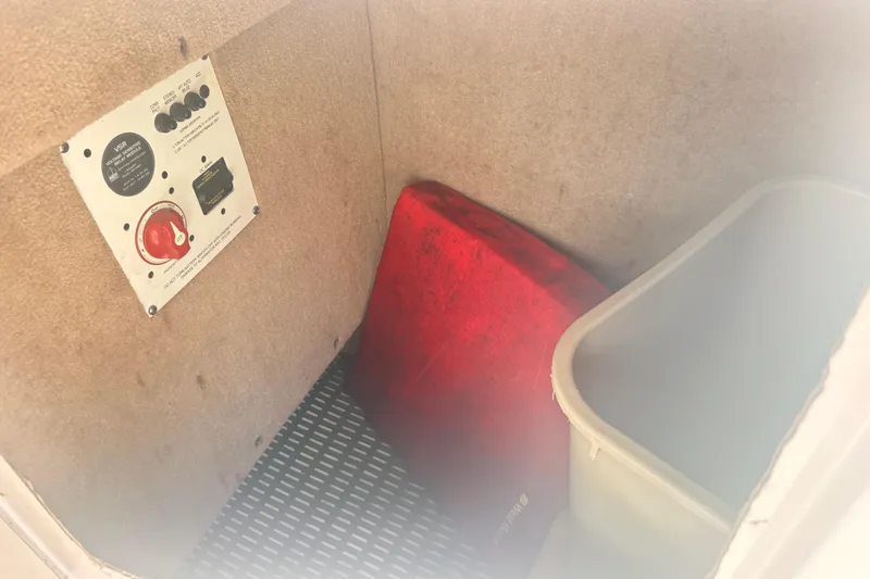 Slide: The Image of Interior storage compartment of 2011 Chaparral 244 Sunesta boat with control panel and red cushion. - 5