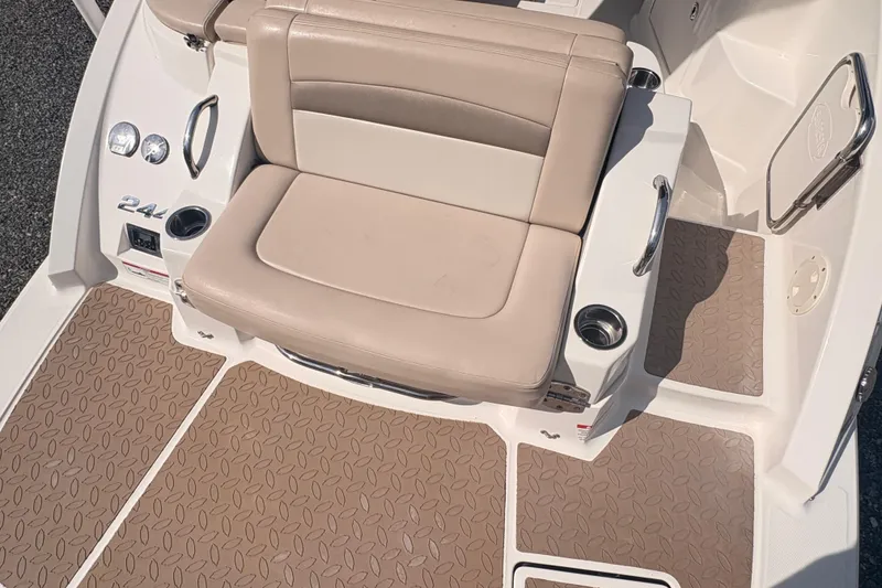 Slide: The Image of 2011 Chaparral 244 Sunesta boat interior with beige seating and textured flooring. - 9