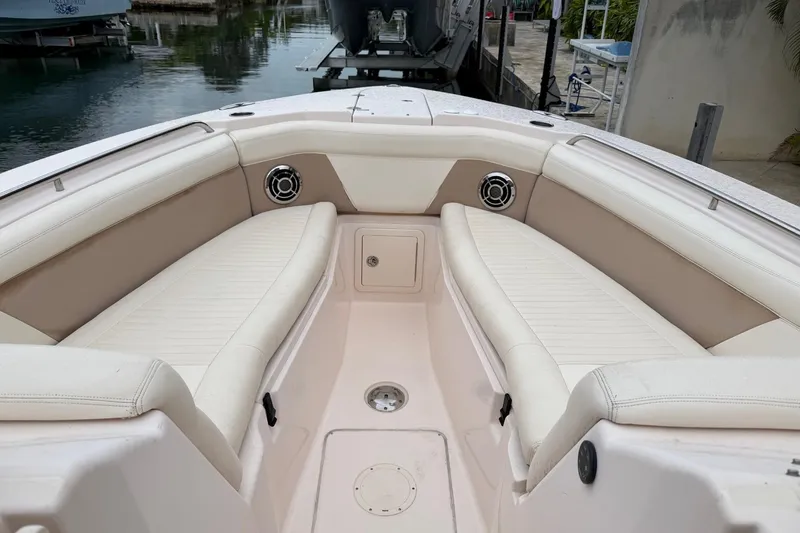 Slide: The Image of 2013 Grady-White Freedom 307 boat interior with beige seating and speakers. - 3