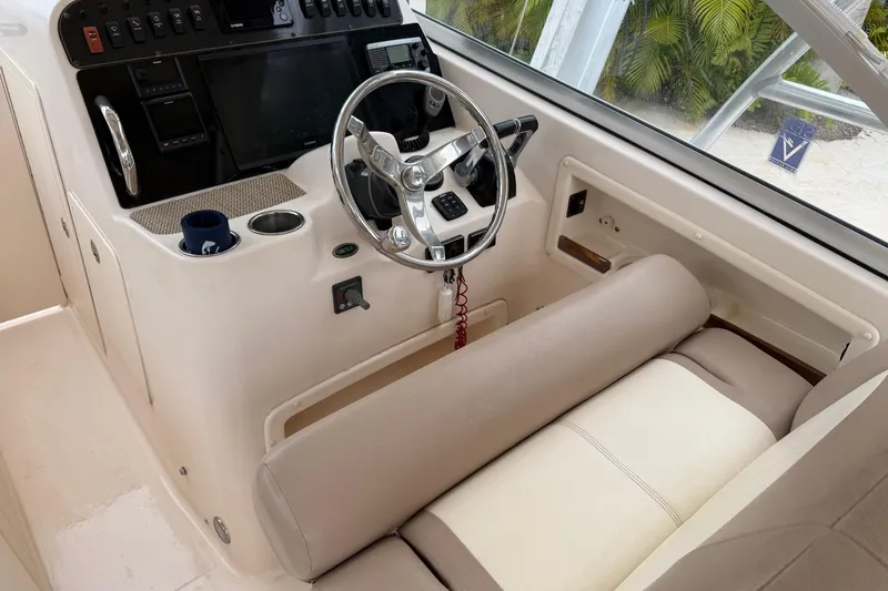 Slide: The Image of 2013 Grady-White Freedom 307 boat cockpit with steering wheel and control panel. - 7