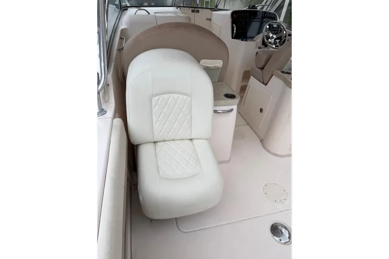 Slide: The Image of Interior of 2013 Grady-White Freedom 307 boat with white seating and helm. - 8