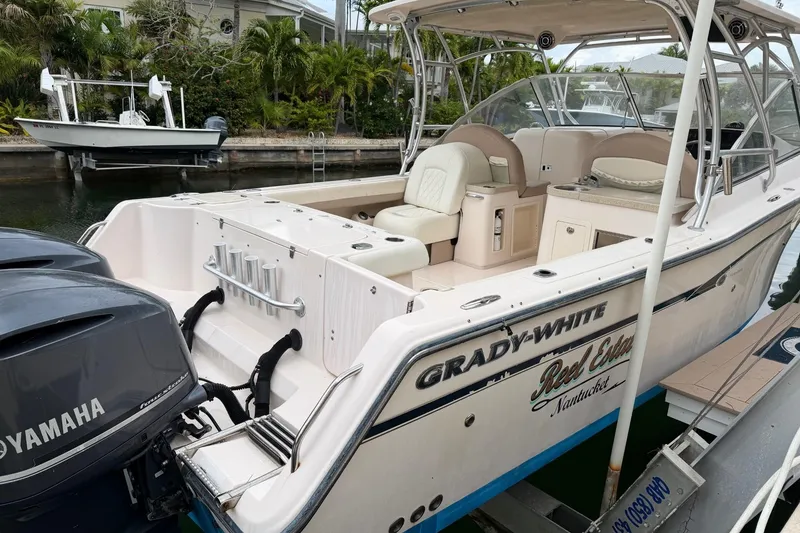 Slide: The Image of 2013 Grady-White Freedom 307 boat docked, featuring Yamaha engines and spacious seating. - 9
