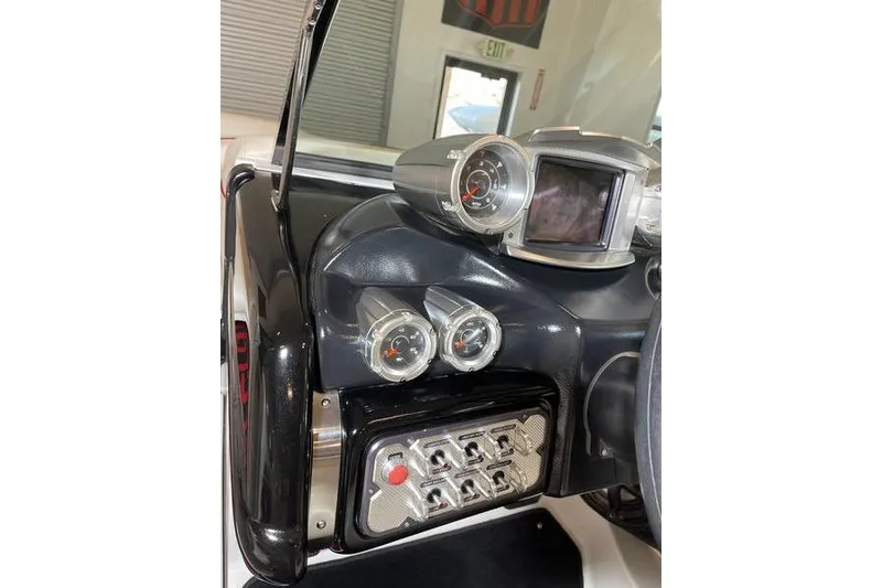 Slide: The Image of Dashboard of a 2010 MasterCraft XStar boat with gauges and controls. - 11