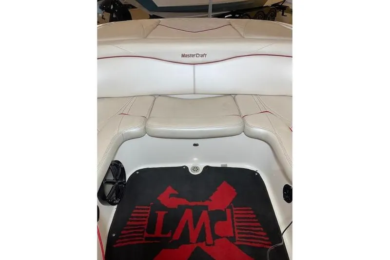 Slide: The Image of 2010 MasterCraft XStar boat interior with white seating and custom floor mat. - 5