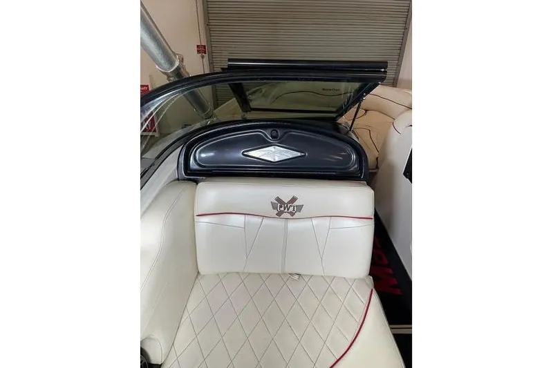 Slide: The Image of 2010 MasterCraft XStar boat interior with white leather seating and red accents. - 7