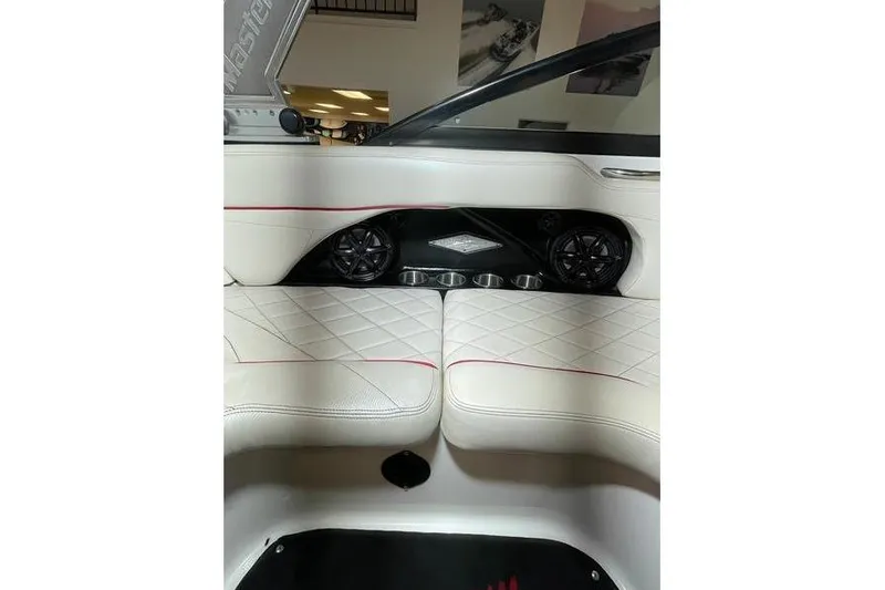 Slide: The Image of Interior of 2010 MasterCraft XStar boat with white quilted seats and speakers. - 9