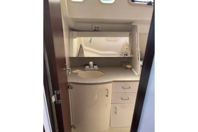 Slide: The Image of Interior of a 2000 Hunter 340 sailboat bathroom with sink and storage cabinets. - 13