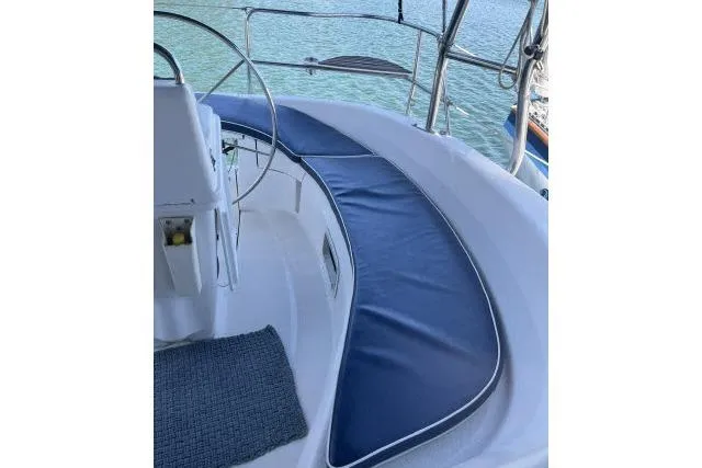 Slide: The Image of Cockpit of 2000 Hunter 340 sailboat with blue cushioned seating. - 18