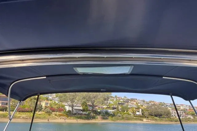 Slide: The Image of View from a 2000 Hunter 340 sailboat canopy overlooking a scenic waterfront. - 19