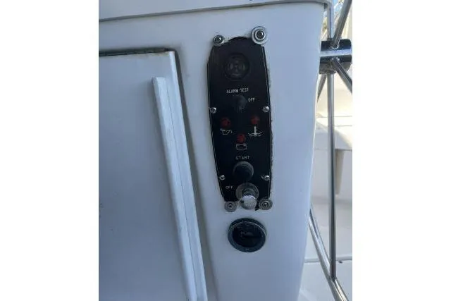 Slide: The Image of Control panel on a 2000 Hunter 340 sailboat, featuring alarm test and ignition switches. - 21