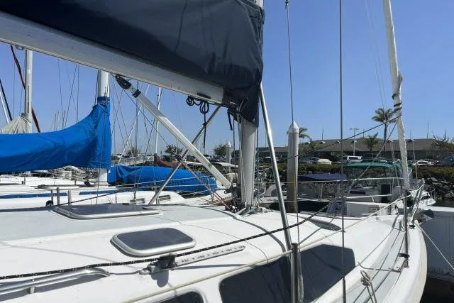 Slide: The Image of Sailboat Hunter 340, 2000 model, docked in a marina under clear blue skies. - 25