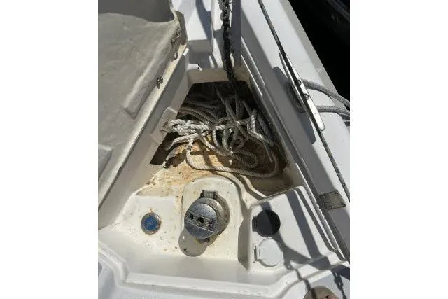 Slide: The Image of Coiled ropes on a 2000 Hunter 340 sailboat deck, near a winch and cleat. - 26