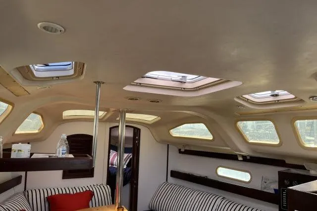 Slide: The Image of Interior of a 2000 Hunter 340 sailboat with skylights and striped seating. - 5
