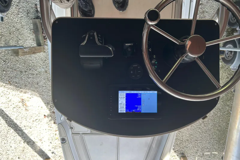 Slide: The Image of Steering console of a 2006 Scout 240 Bay Scout boat with navigation display. - 3