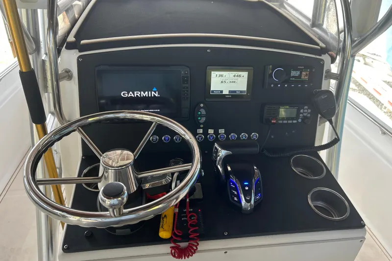 Slide: The Image of 2006 Scout 240 Bay Scout boat dashboard with Garmin navigation system and controls. - 6