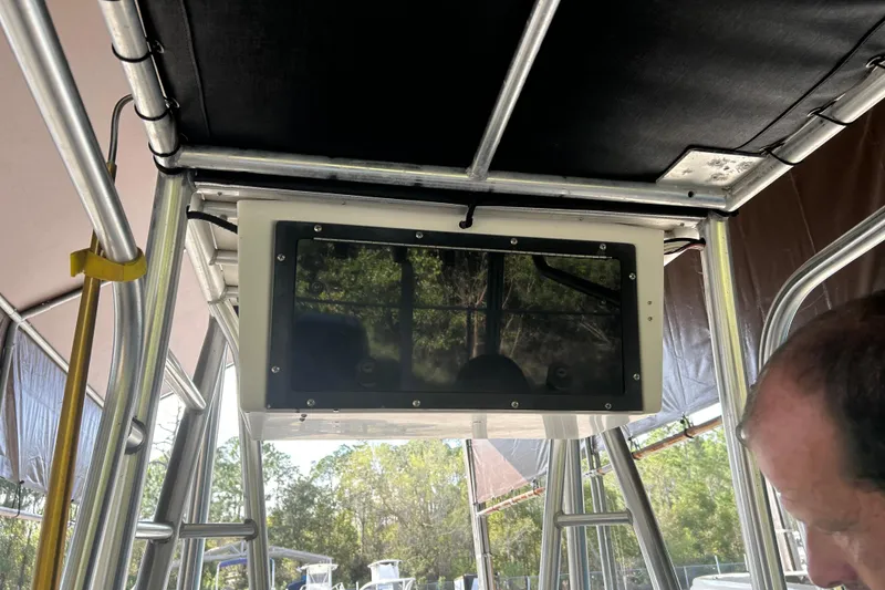 Slide: The Image of 2006 Scout 240 Bay Scout boat interior with overhead console and metal framework. - 7