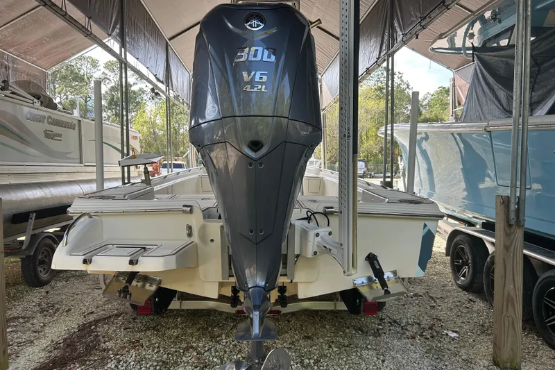 Slide: The Image of 2006 Scout 240 Bay Scout boat with powerful V6 engine in storage. - 8